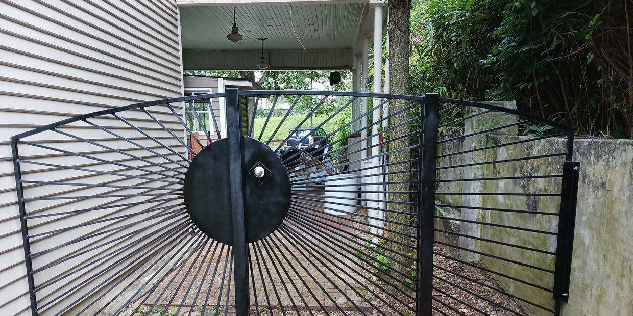 Custom welded and fabricated ornamental iron gate on a 1902 home.  