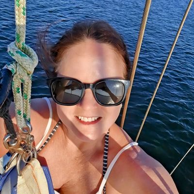 Sitting in a bosun's chair at the top of the mast of Cest Si Bon