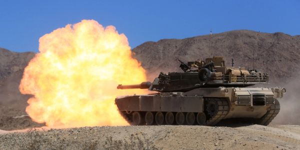 Tank firing a shell with explosion.