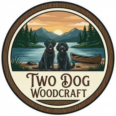 Logo of two dogs by a lake with mountains and a canoe.