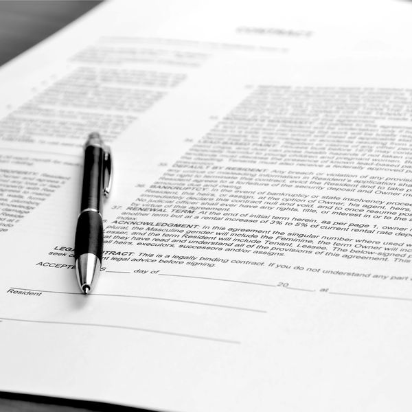 Pen resting on a legal contract document.