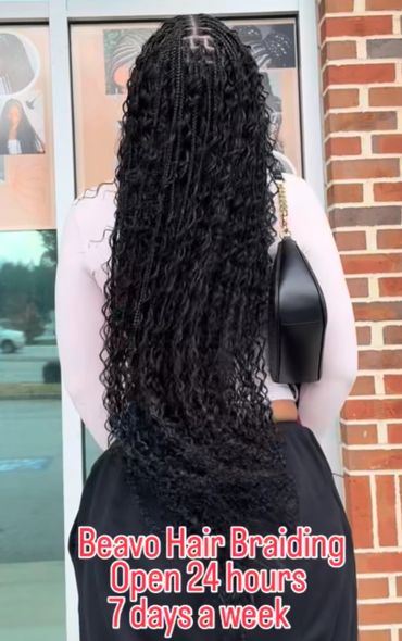 Woman with long braided and curly hair showcasing Beavo Hair Braiding services.
