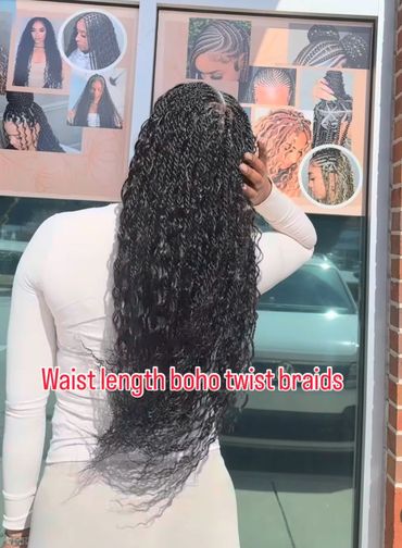 Person showcasing waist-length boho twist braids hairstyle.