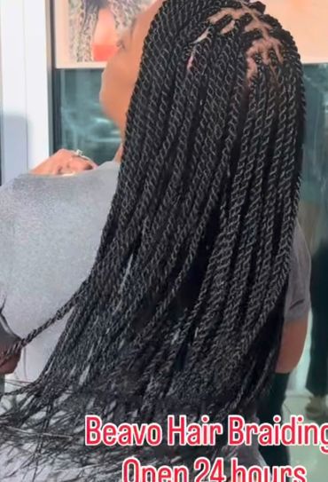 Woman with mid-back length Senegalese twist braids at Beavo Hair Braiding.