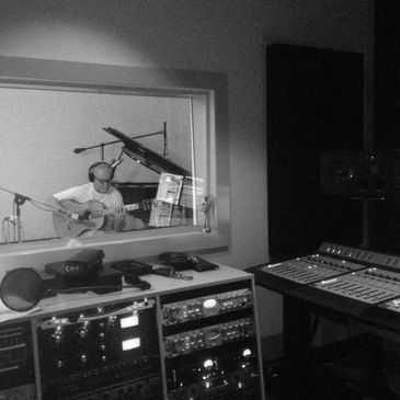 Bill Atkinson playing guitar in the recording studio.