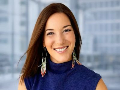 Smiling woman with long hair and colorful earrings