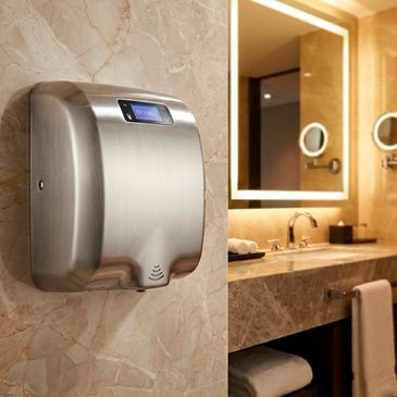 Modern stainless steel hand dryer on a marble wall in a luxurious bathroom.