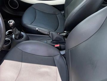 Interior of a car showing front seats and manual gear shift.
