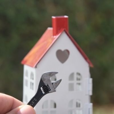 Small wrench in front of model house