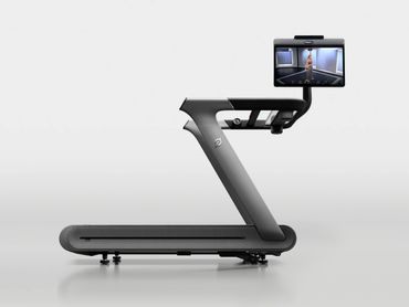 Modern treadmill with a large screen displaying a virtual fitness instructor.