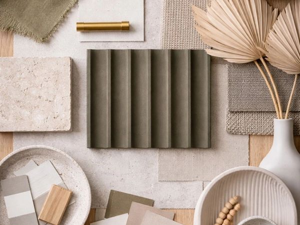 A neutral-toned flat lay of fabric, tiles, and decorative items in natural textures and earthy colors.