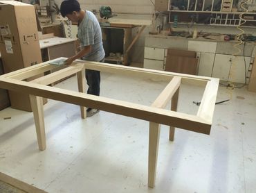 A person measuring a table