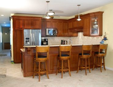 Item: KTC021 – Cherry Traditional style with recessed panels and stone top.