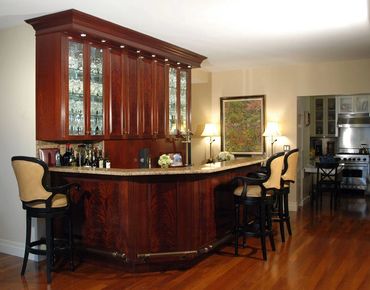 Traditional bar with marble counter and glass framed doors.