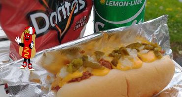 Chili cheese hot dog with Doritos and lemon-lime soda on the side.