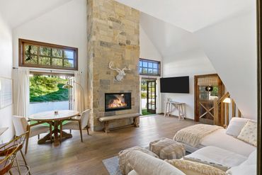 Bright living room with stone fireplace and cozy seating.