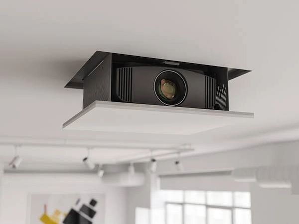 Ceiling-mounted projector in a modern room.
