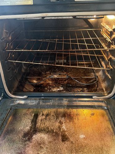 Dirty oven with food stains and grime inside.