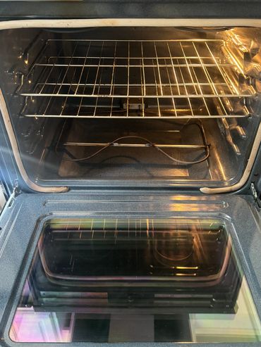Open and clean oven with racks inside.