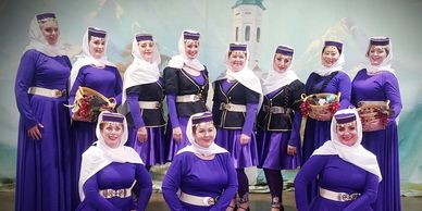 Al-Bahira Dancers pose in purple, black and white Azeri/Yalli stage costumes