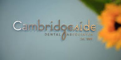 Photo of a light green wall with metallic text reading Cambridgeside Dental