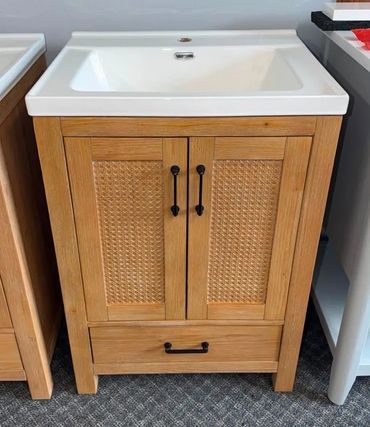 Wooden bathroom vanity with white sink.