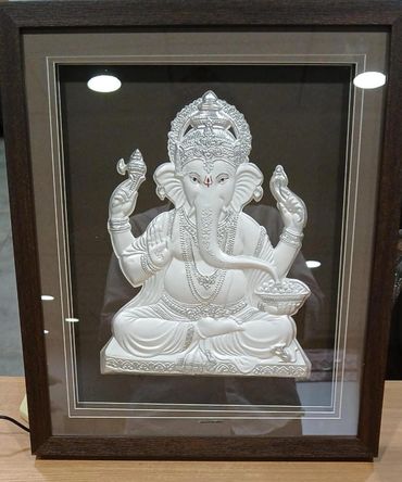 Framed silver artwork of Lord Ganesha with intricate details.