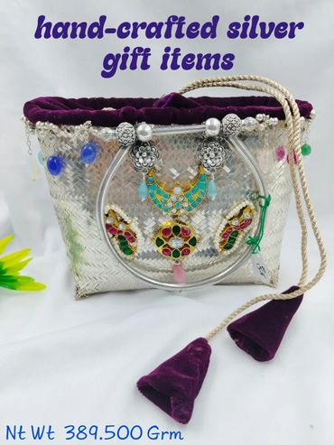 Hand-crafted silver gift items with colorful embellishments and purple velvet accents.