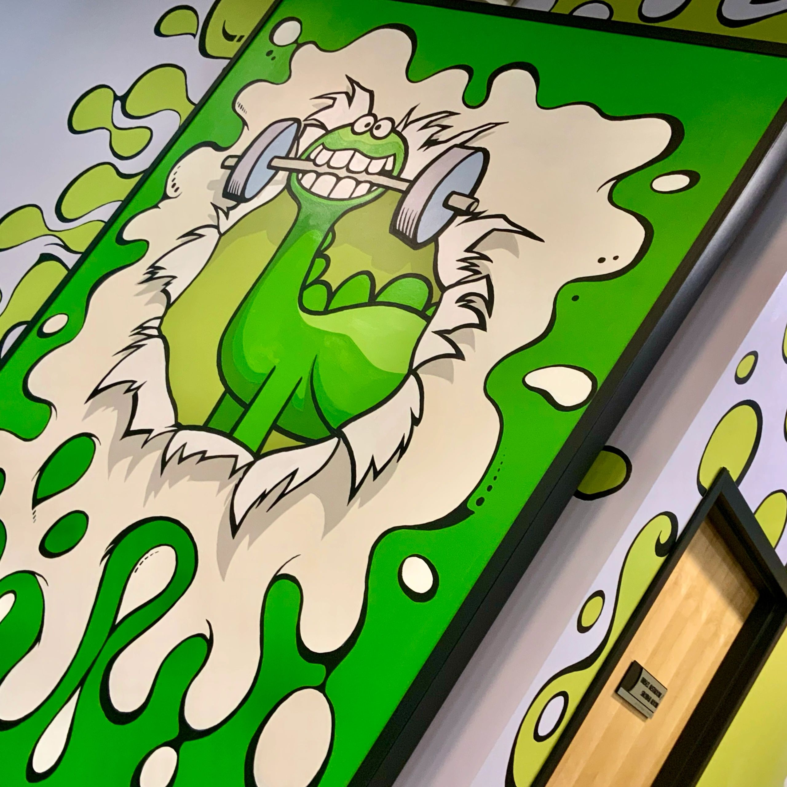 Prominent Gronk the Dinosaur Mural Inside the Gym
