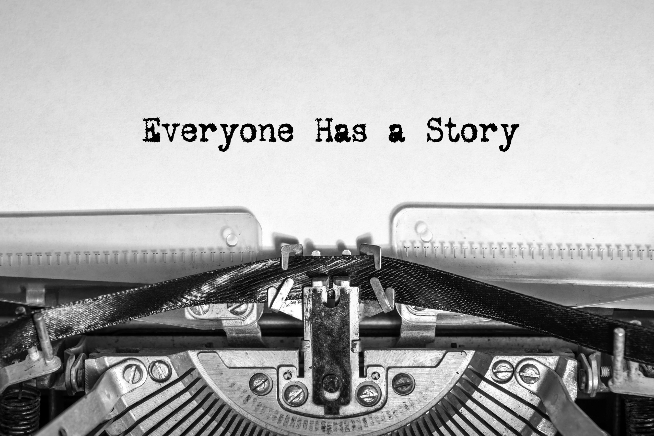 Image of a typewriter ribbon with typed words "Everyone has a story"