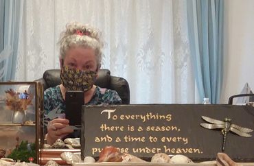 Selfie in mirror, artist wearing Covid mask, one of 1,000 she made during the Pandemic..