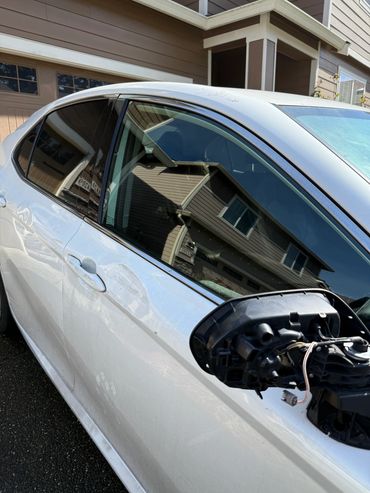White car with damaged side mirror