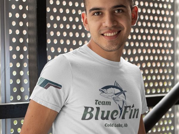 Smiling man wearing a white Blue Fin team t-shirt.