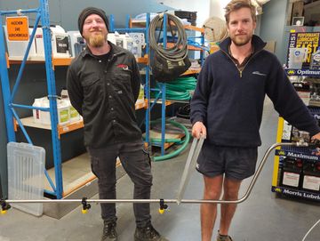 Technician with Dynamic happy client custom built spray boom