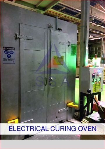 Industrial electrical curing oven with safety warnings and control panel.