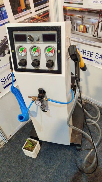 Industrial control panel with gauges and hoses, displayed at an exhibition booth.