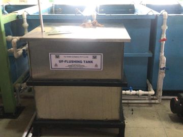 Industrial UF-flushing tank with connected piping and pump setup.