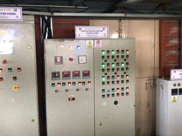 Industrial control panels labeled Transporter, Circulation and Heating, and Rectifier with various switches and indicators.