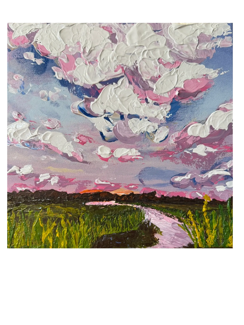 Thick pastel clouds over a green field at sunset with a winding river.