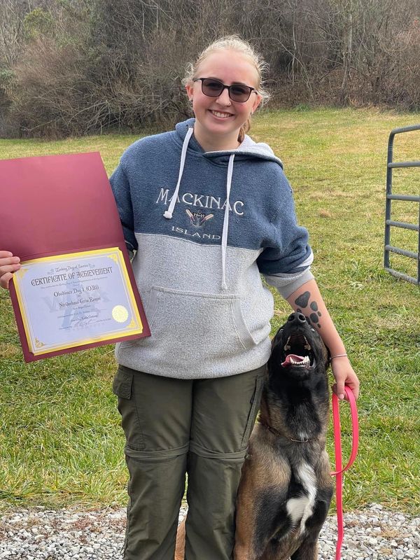 Kaitlin and her dog, Reaper, after earning their OB1 title.