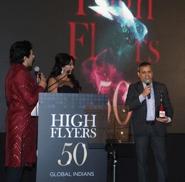 Man receiving an award at High Flyers 50 Global Indians event.