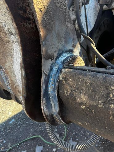 Close-up of a welded metal joint on industrial machinery.