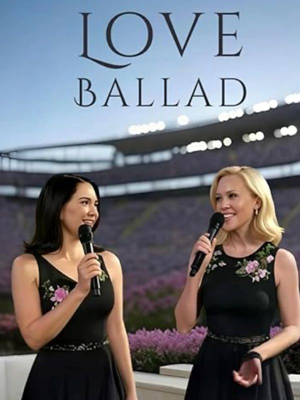 Two women singing with microphones at an outdoor stadium event.