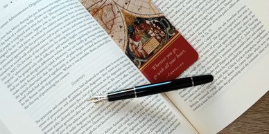 An open book with pen and bookmark.
