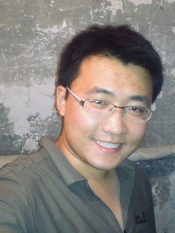 Photo of Zilong Guo smiling in a social meeting setting.