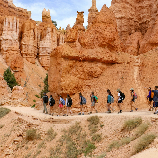 Group of teens hiking and exploring a canyon