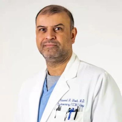 Portrait of a male doctor in a white coat.