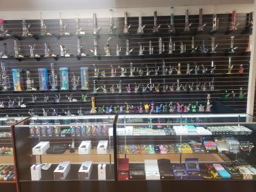 Rows of glass pipes and smoking accessories on display