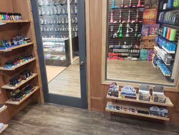 Storefront entrance and mirrored display area at Lit Tobacco in Waterford Township