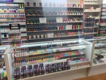Fully stocked display shelves of tobacco and smoking accessories